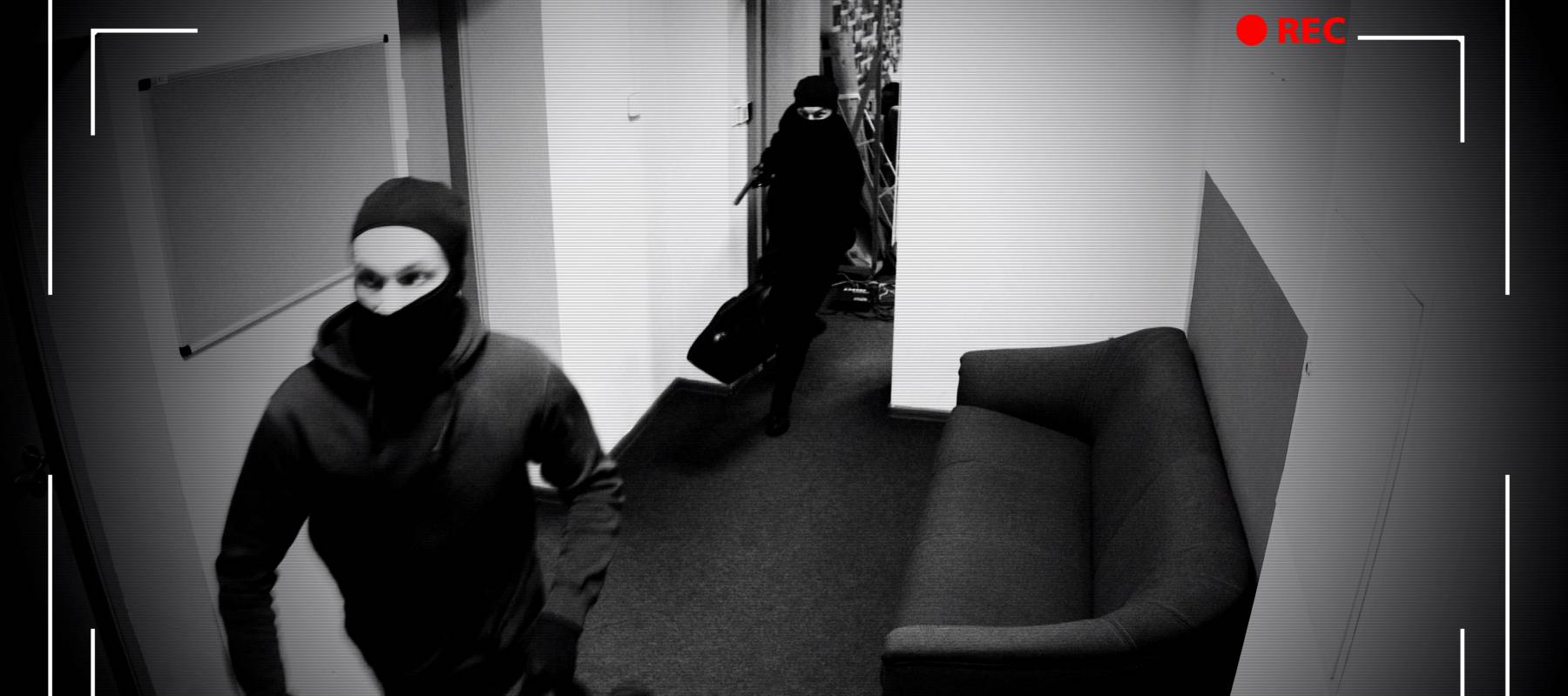 Stock footage of camera recording masked robbers.