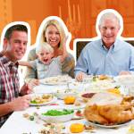 A multi-generational family sits around a table set up with a Thanksgiving feast, smiling for the camera.