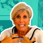 Suze Orman speaking and gesturing during a video interview.