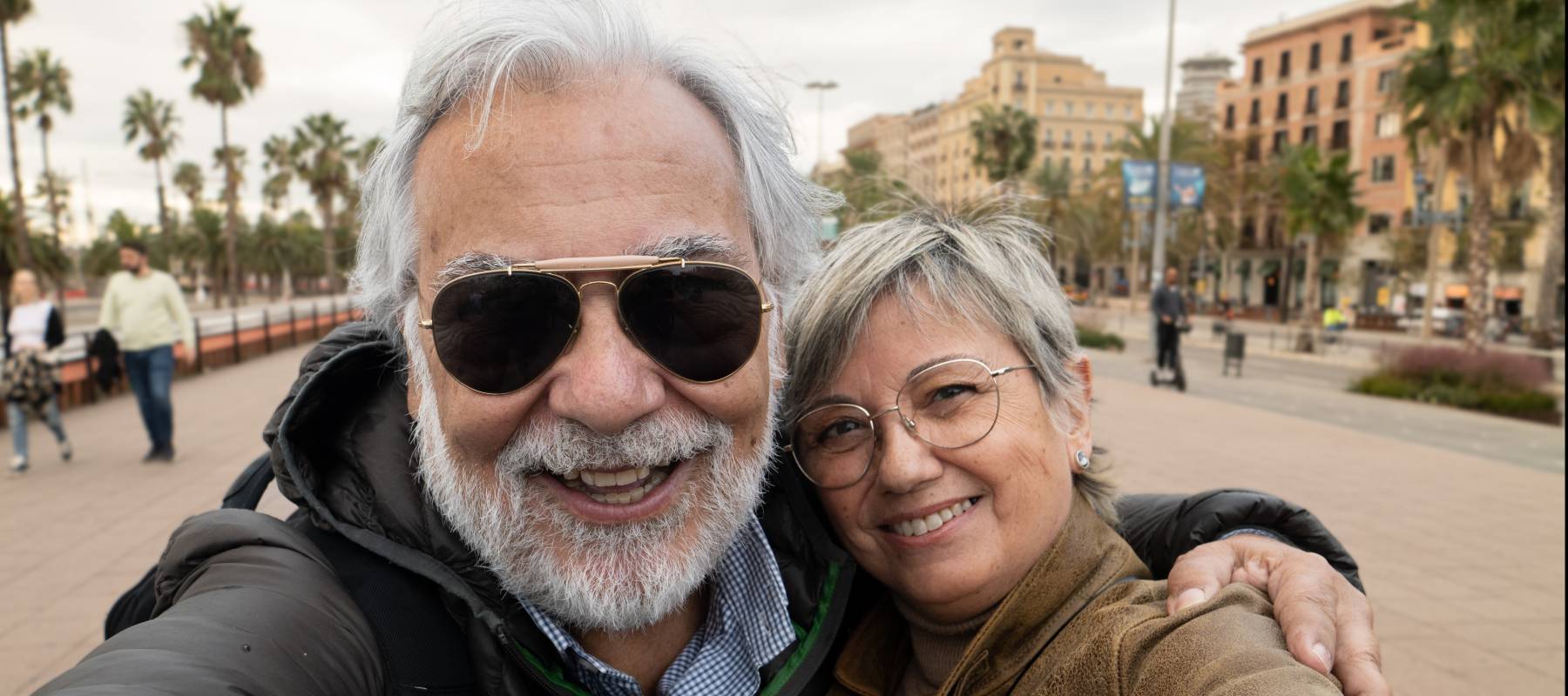 Selfie portrait of a heterosexual retired couple having fun in a city. Older people on vacation