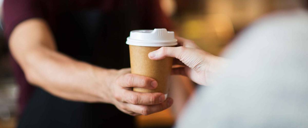 bartender serving customer at coffee shop