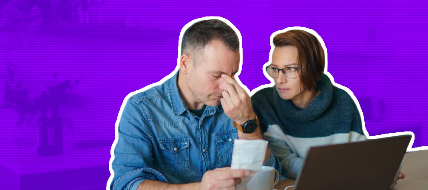 Young couple sits at kitchen table looking stressed over financial documents.