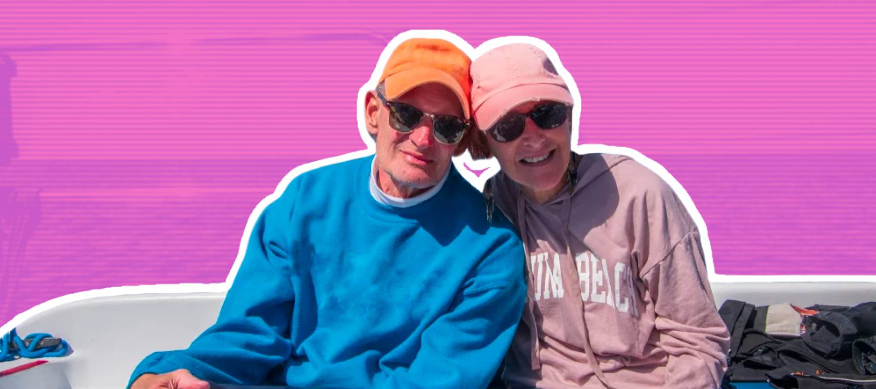 Happy couple poses on a boat.