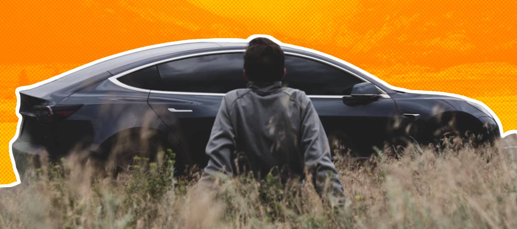 Photograph of a Tesla model 3 with a man in front of it with mountains in the background.