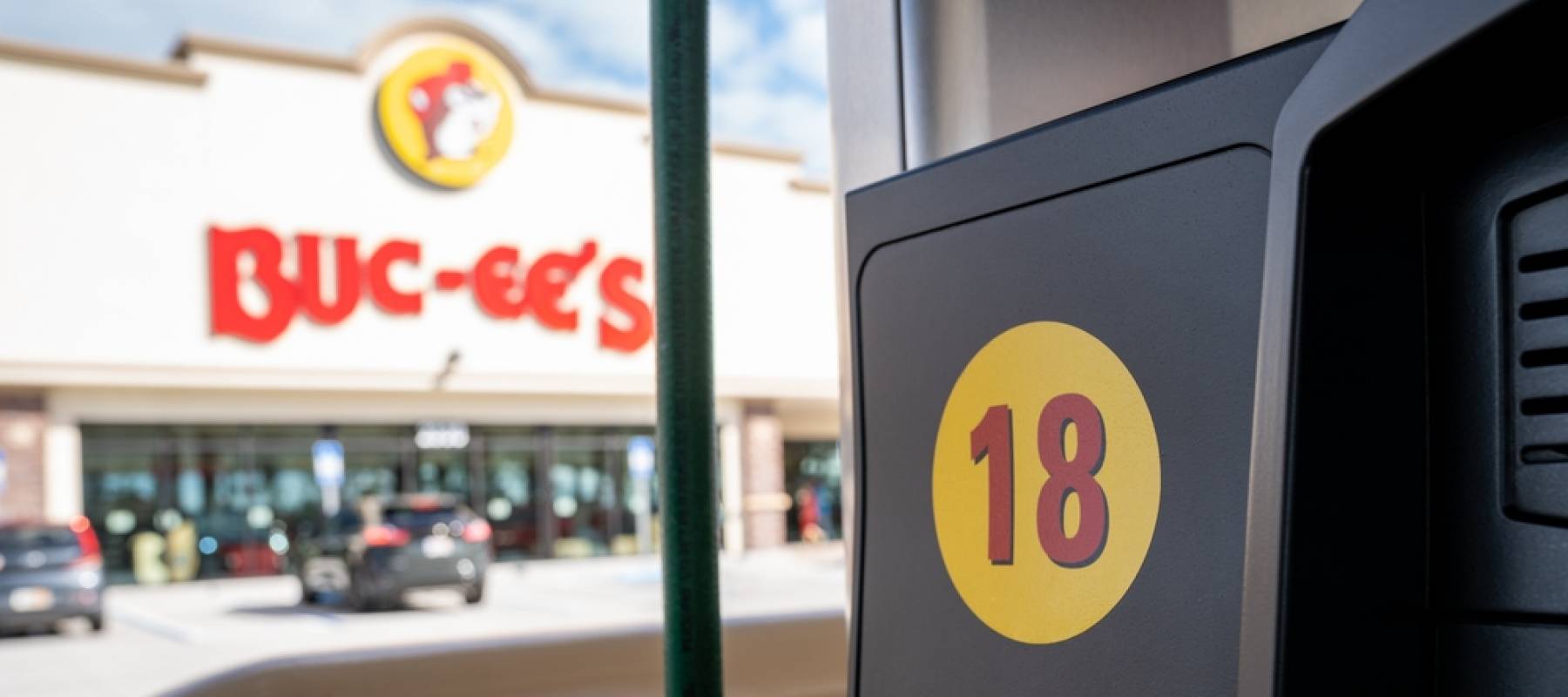 Fuel pump outside of a Buc-ees, a large convenience store and gas station featuring a beaver mascot.