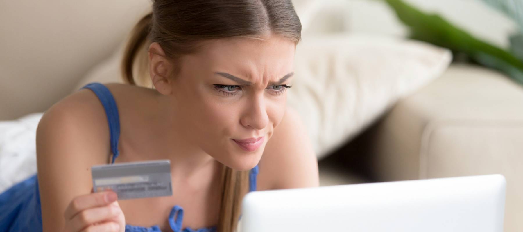 Confused woman having problem with credit card