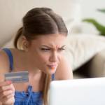 Confused woman having problem with credit card