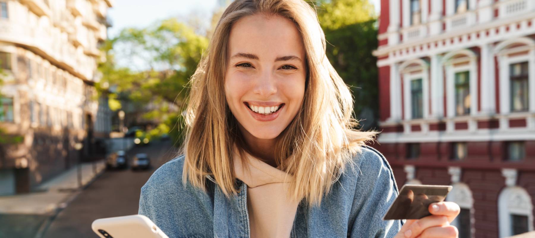 Woman smiles with credit card