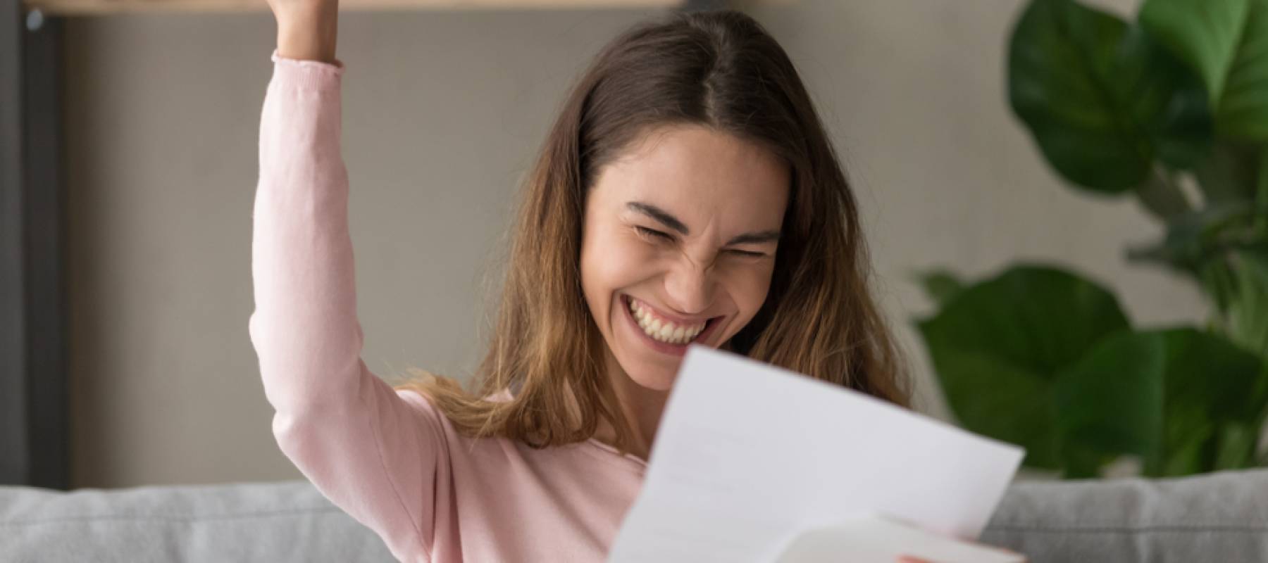 Woman celebrating after receiving a big tax refund.