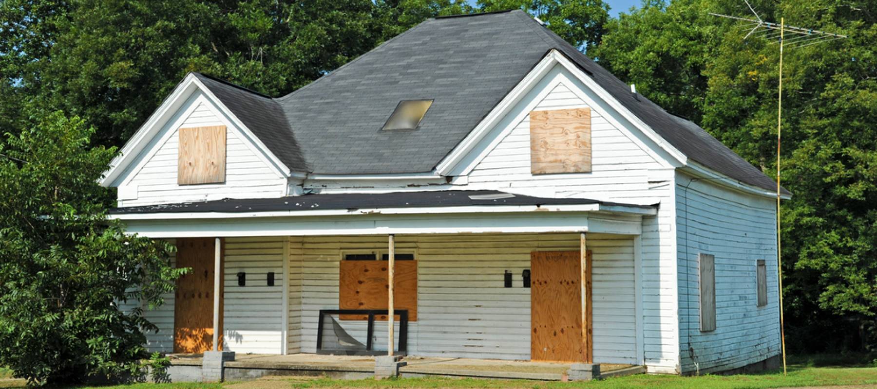 Abandoned House with Boarded up Windows and Doors