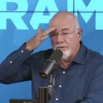 Dave Ramsey speaks on set of his show with his hand on his brow.