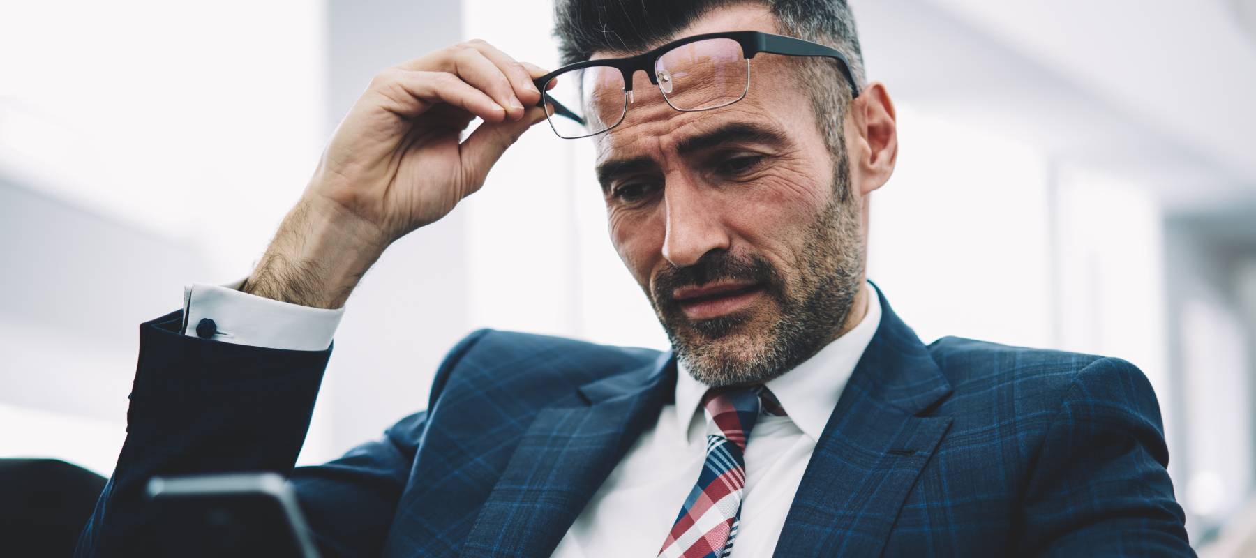 Mature successful entrepreneur dressed in formal wear reading banking notification on smartphone device