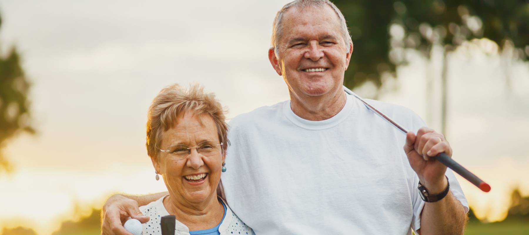 portrait of happy senior couple enjoying active lifestyle playing golf
