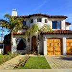 Stately looking home with palm trees in the yard.