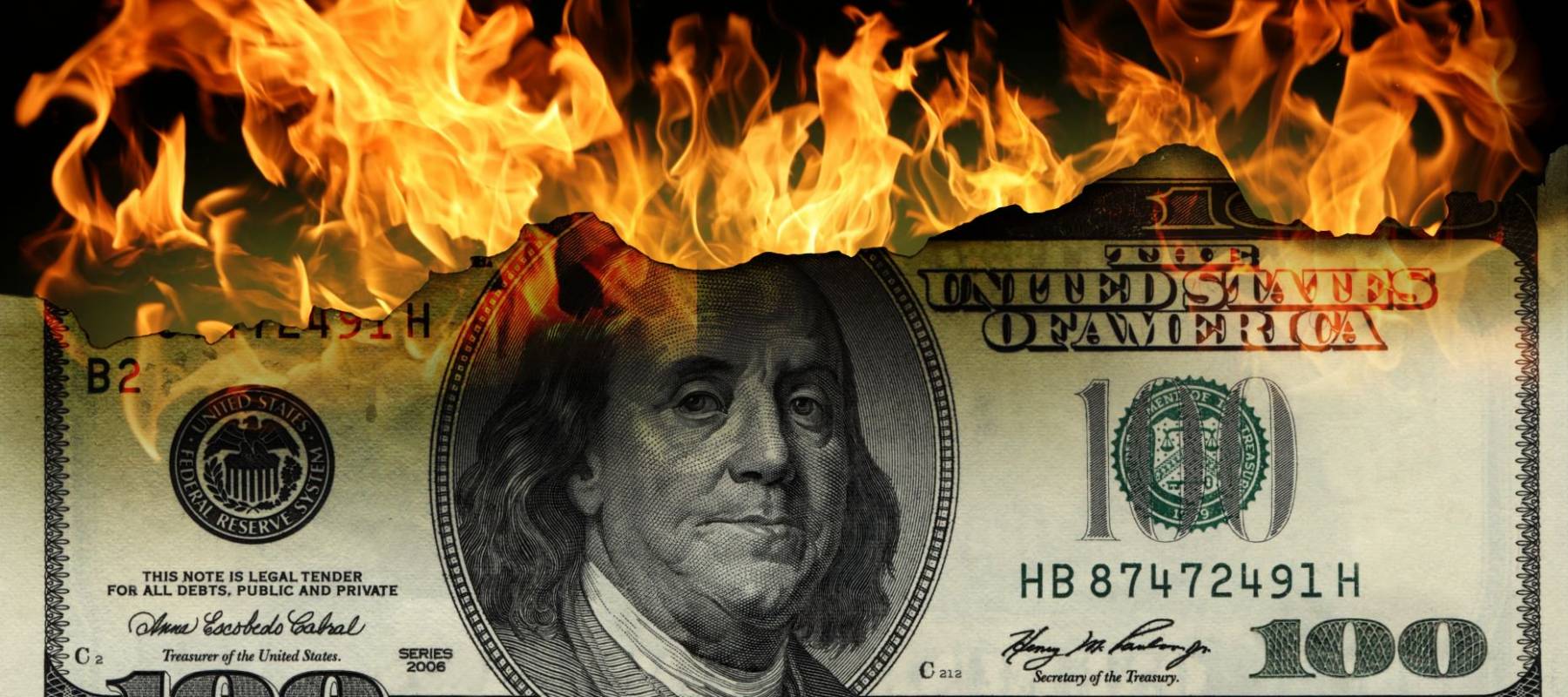 Burning dollars close up over black background