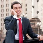 Young businessman calls on mobile in downtown