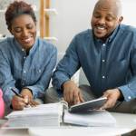 Happy African Couple Doing Retire Finances Plan And Money Budget
