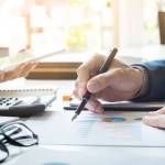 Administrator business man financial inspector and secretary making report, calculating balance. Internal Revenue Service checking document. Audit concept