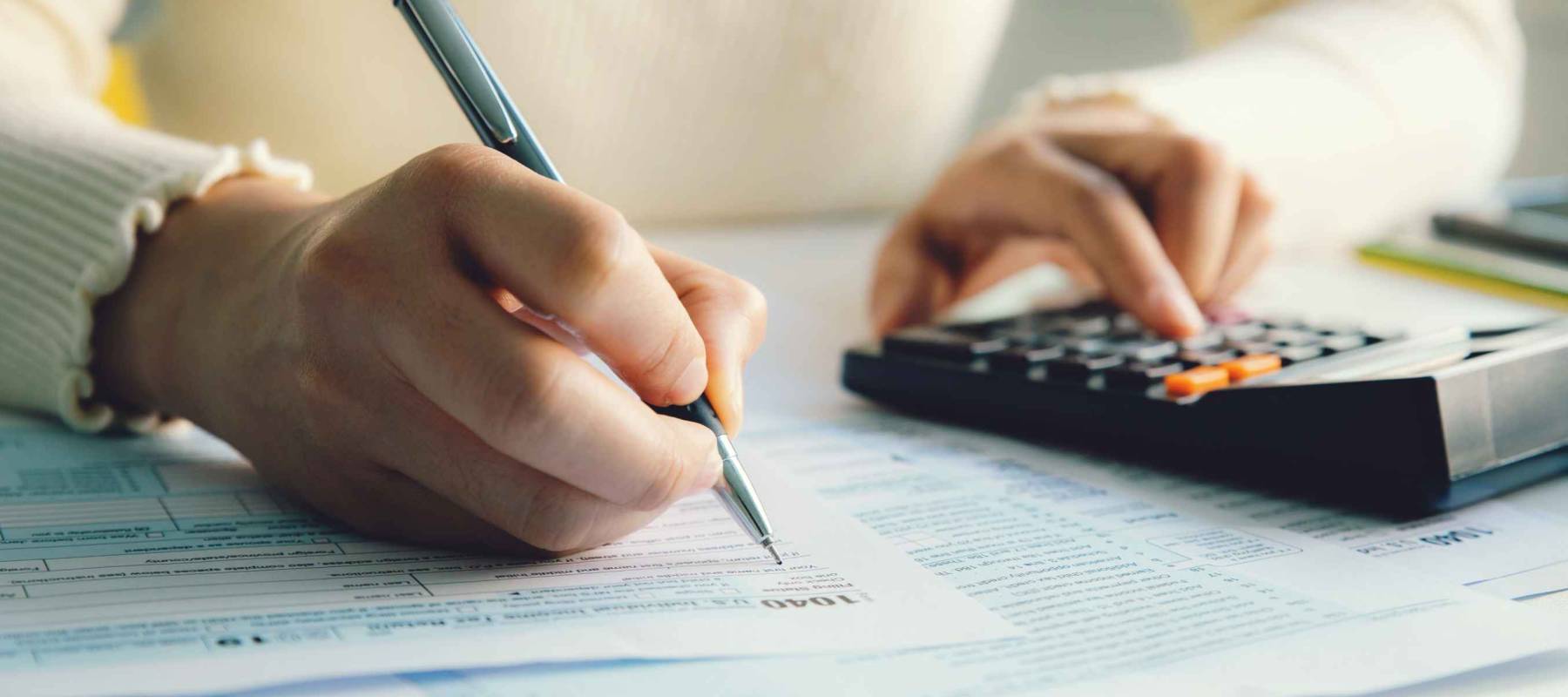 Closeup woman filling form of Individual Income Tax Return,
