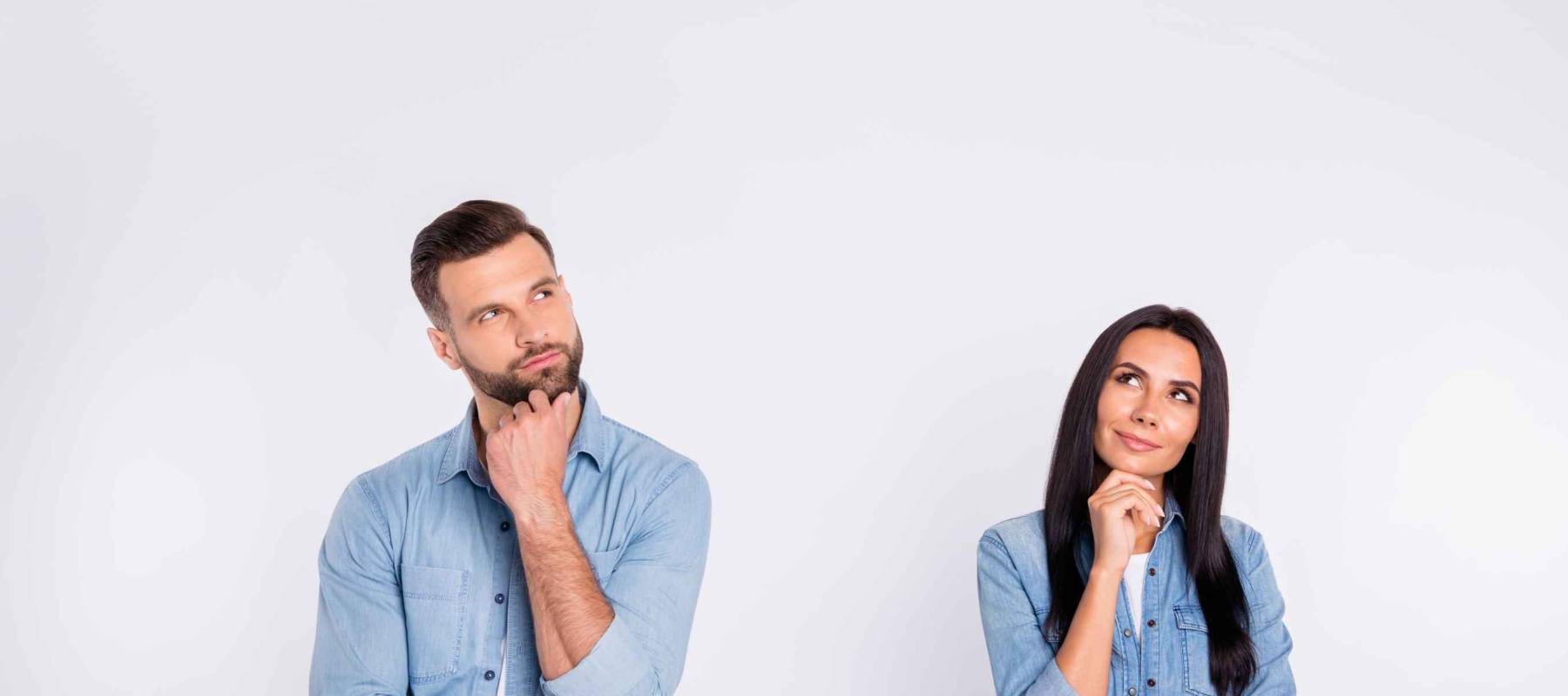 Pensive couple on light background. Thinking about answer for question