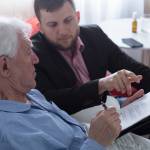 Terminally ill senior signing last will and testament