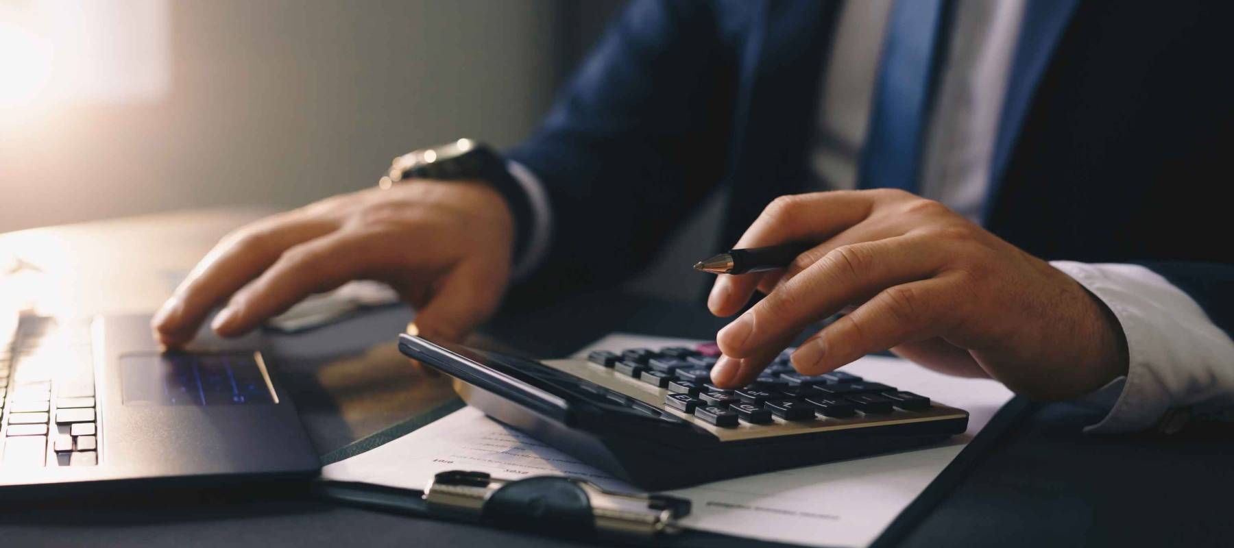 Businessman calculating the financial statement of his business. Accounting and Tax.