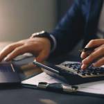 Businessman calculating the financial statement of his business. Accounting and Tax.