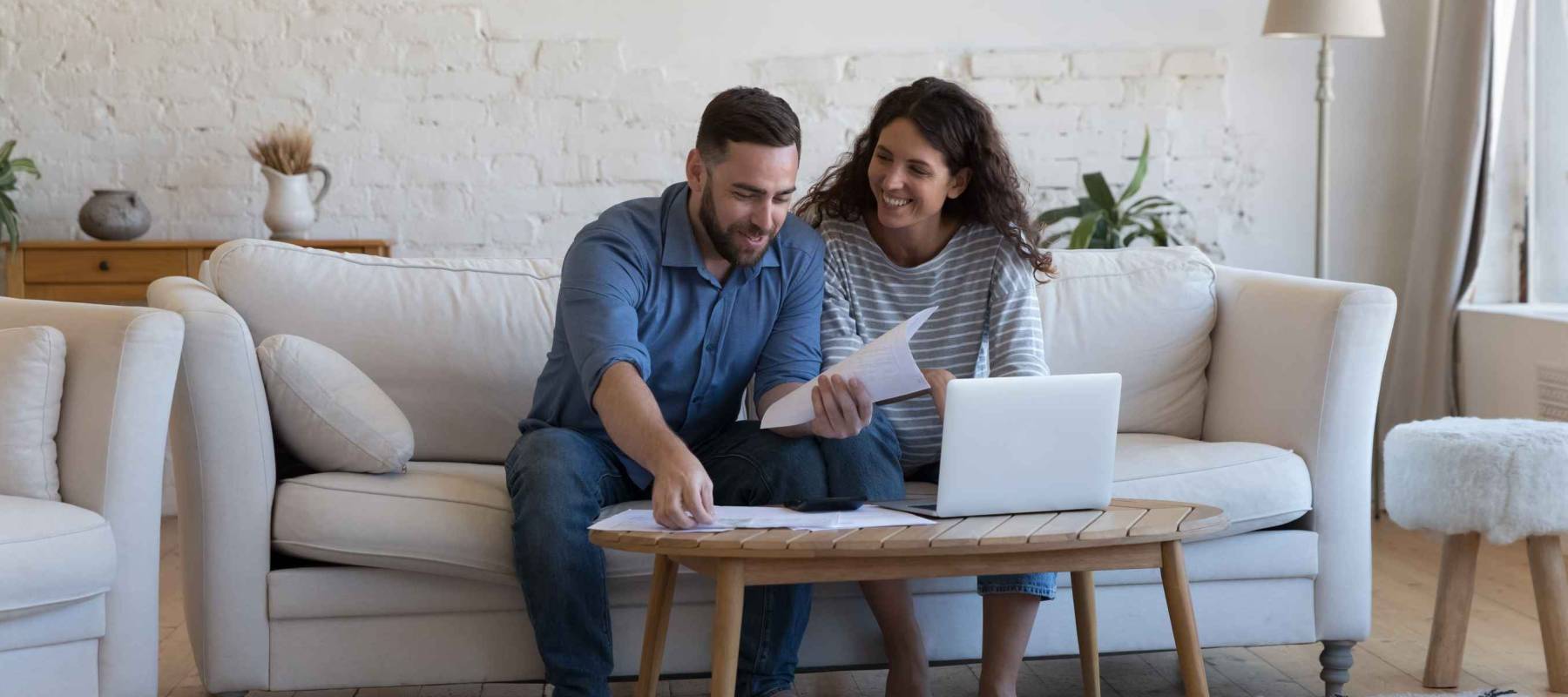 Millennial wife and husband sorting out bank papers,