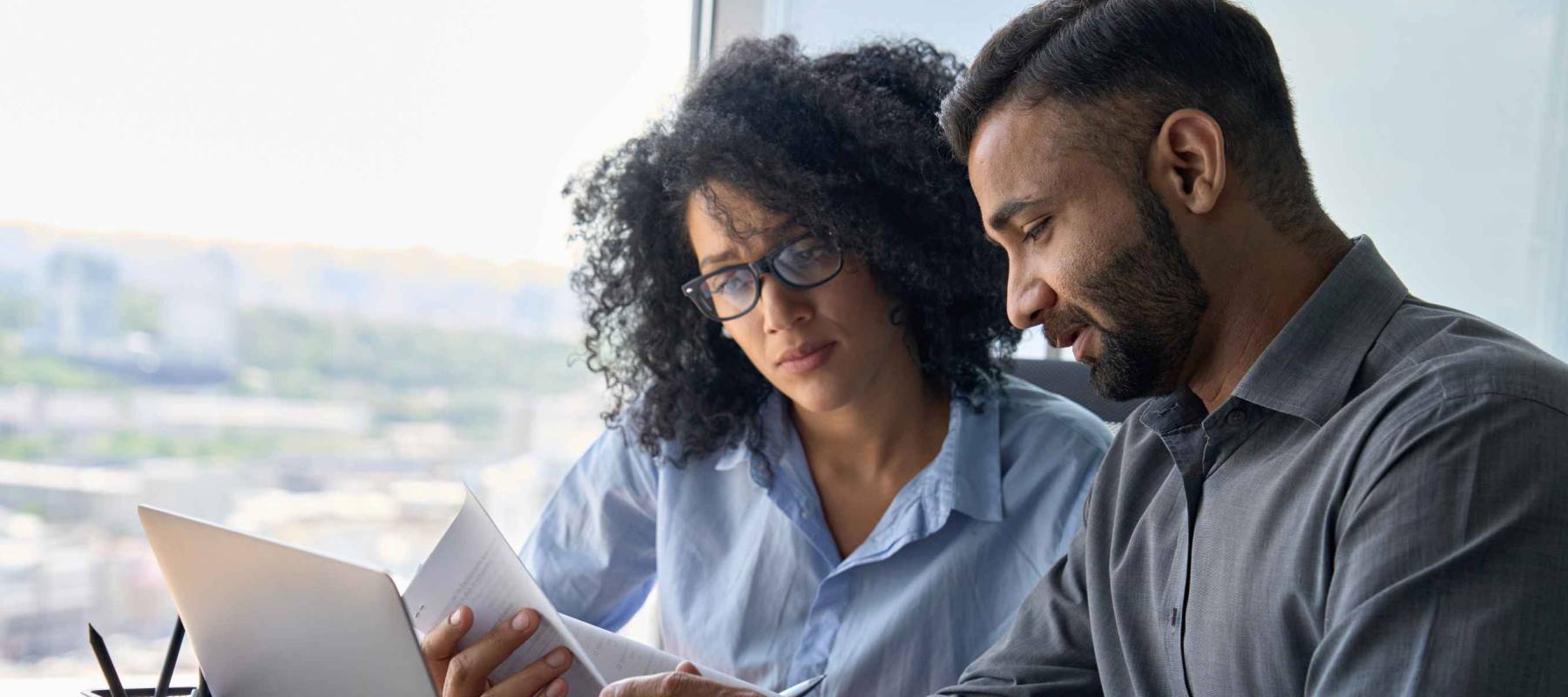 Multiethnic male indian mentor and female African American intern