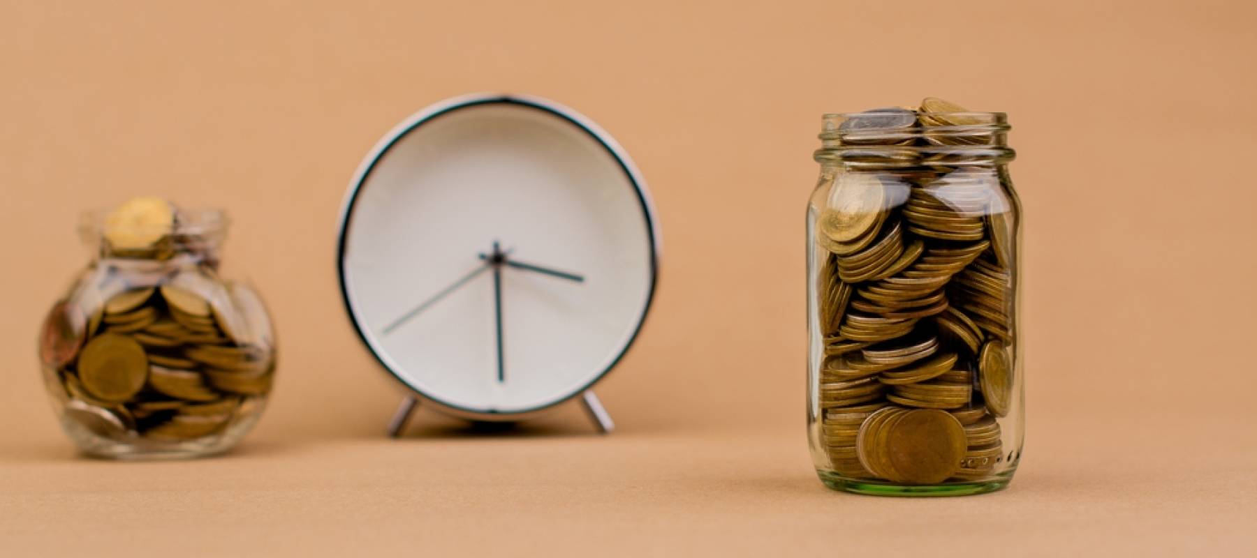 money and time saving money in a glass jar Saving money creates the future. Investment savings. Income. Investment. Cash flow. Coins. Money saving and financial investment concept