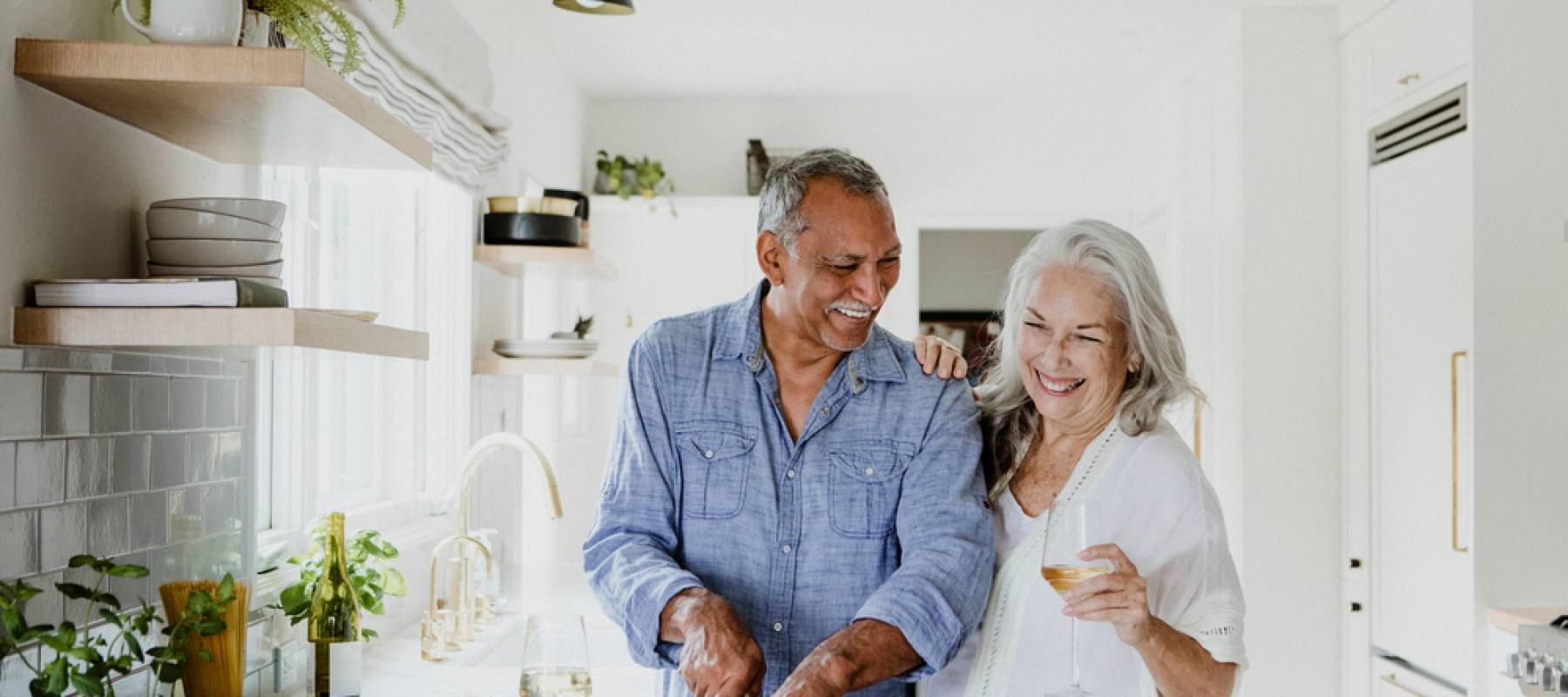 Elderly couple cooking in a kitchen