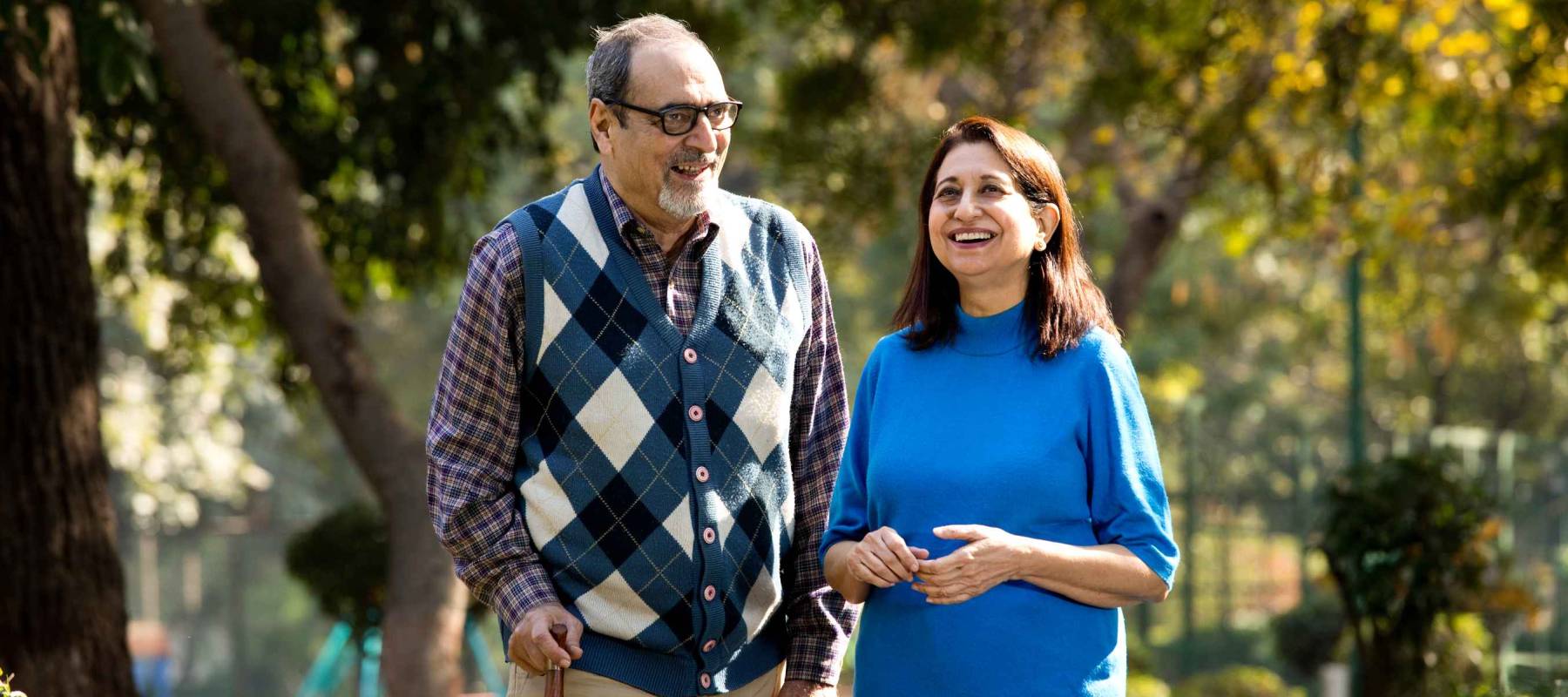 Happy senior couple admiring view at park