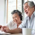 Relaxing Asian Senior couple making video call and talking with family