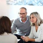 Senior couple meeting financial adviser for investment
