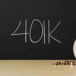 Piggybank with 401k written on a blackboard in the background. Money beside the piggybank with a hand putting a coin in.