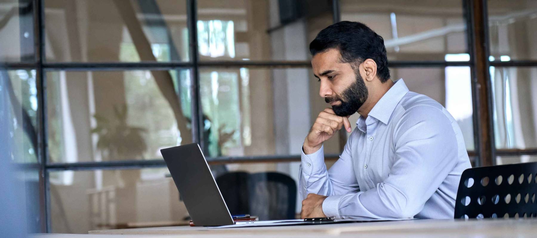 Thoughtful concentrated indian business man entrepreneur investor