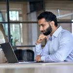 Thoughtful concentrated indian business man entrepreneur investor