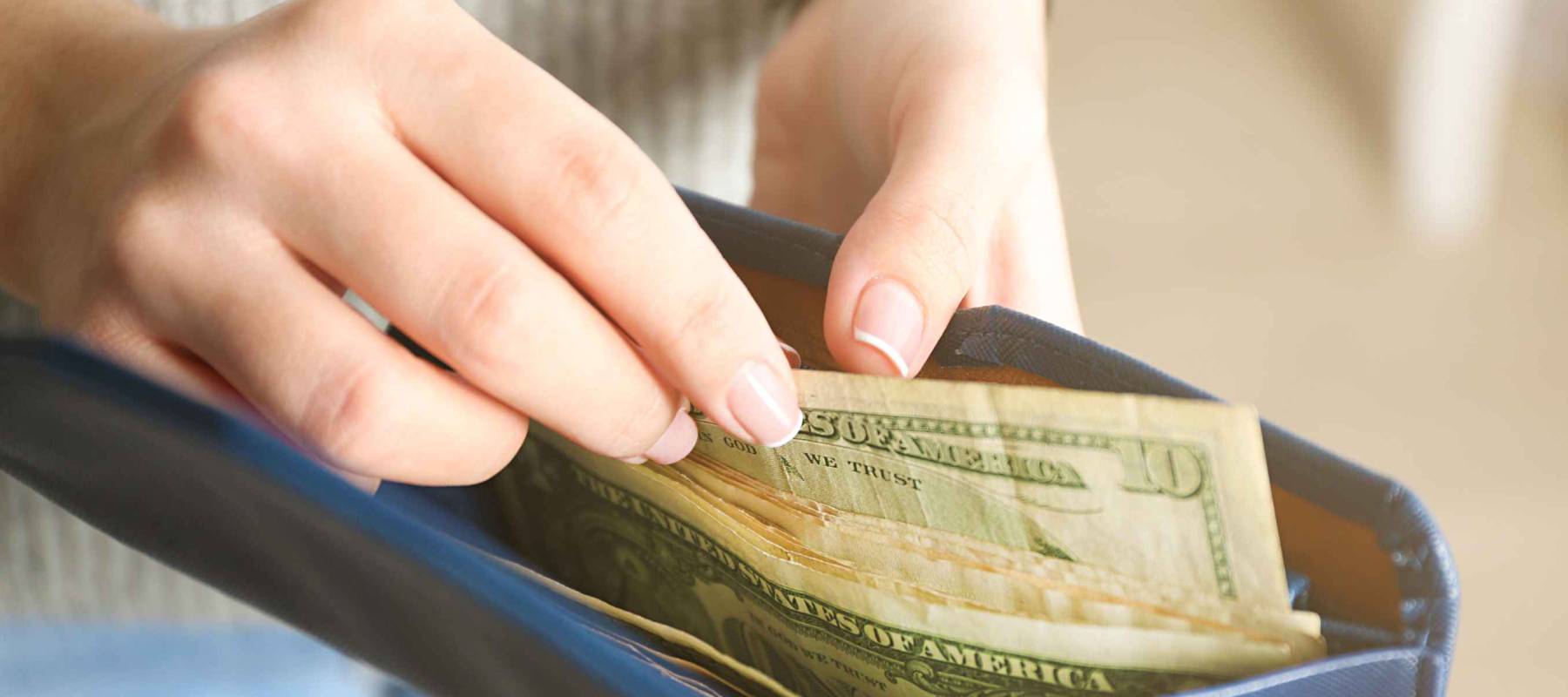 Girl with blue wallet full of money