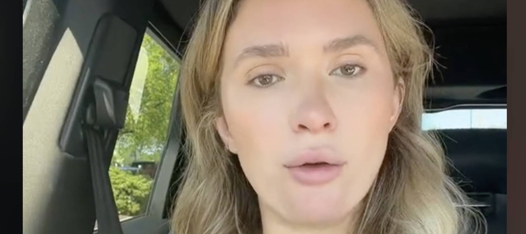 Olivia Reeves sitting in a car facing camera during a TikTok video.