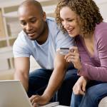Happy couple using credit card to shop online conveniently