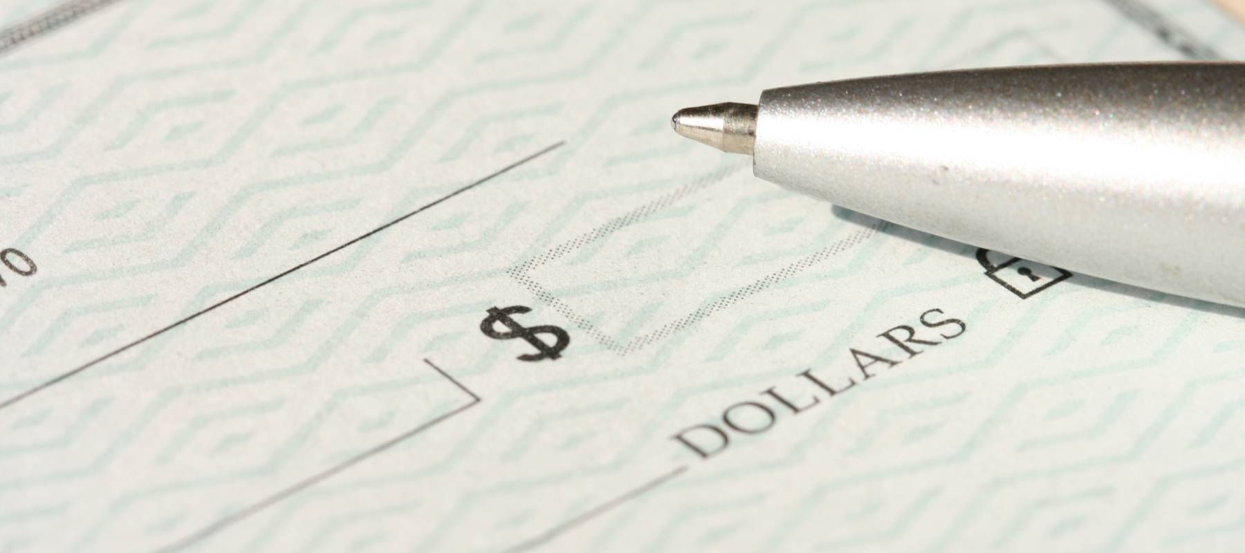 paycheck with pen on top