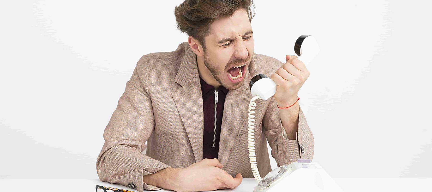 man yelling on phone in frustration
