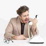man yelling on phone in frustration