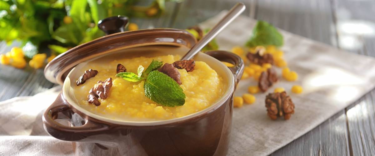 Delicious cornmeal porridge with walnuts on napkin