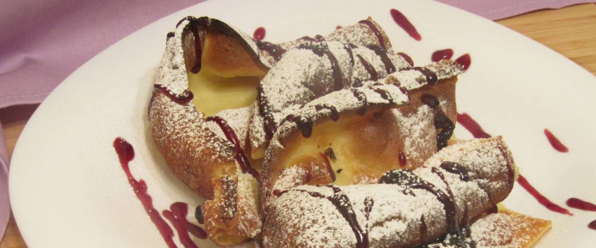 Pannukakku with blueberry jam and powdered sugar.