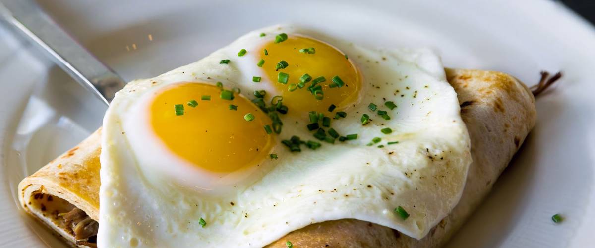 Potato Crepes with baked sunnyside eggs chives breakfast dish