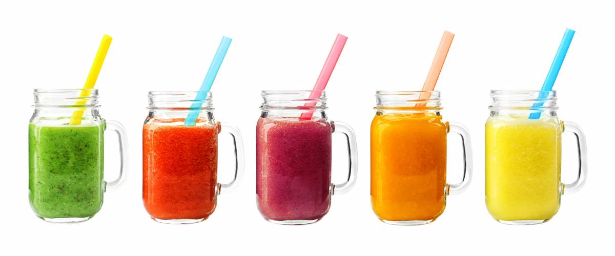 Collage of glass jars with fresh delicious smoothie and straw on white background.