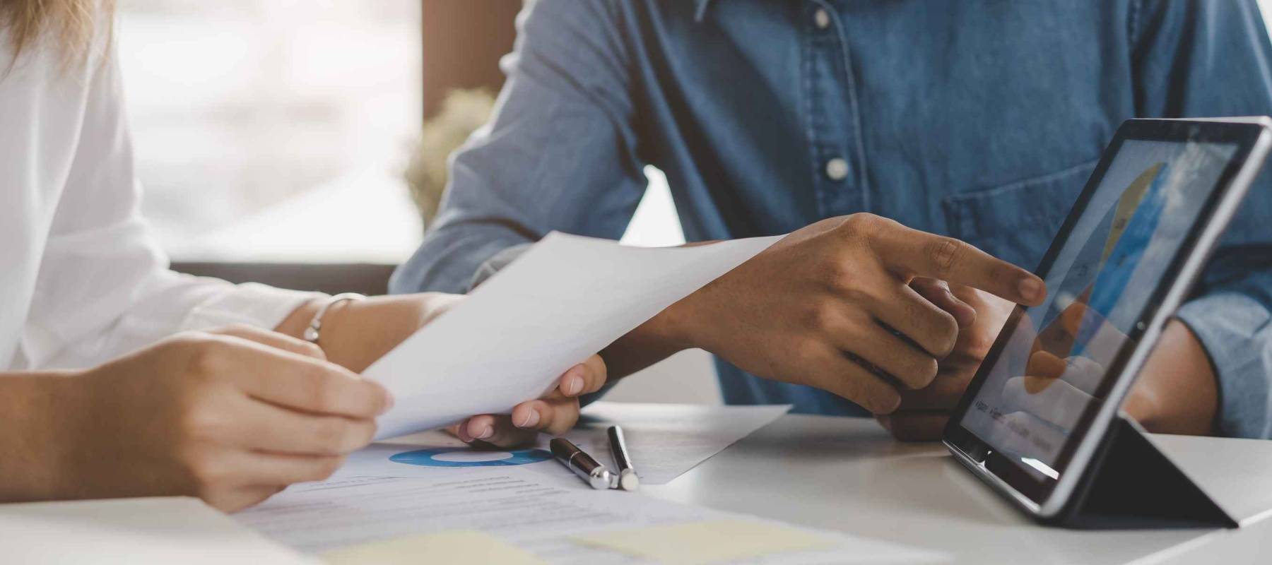 financial advisory services. Asian advisor showing plan of investment to clients in the consultancy office.