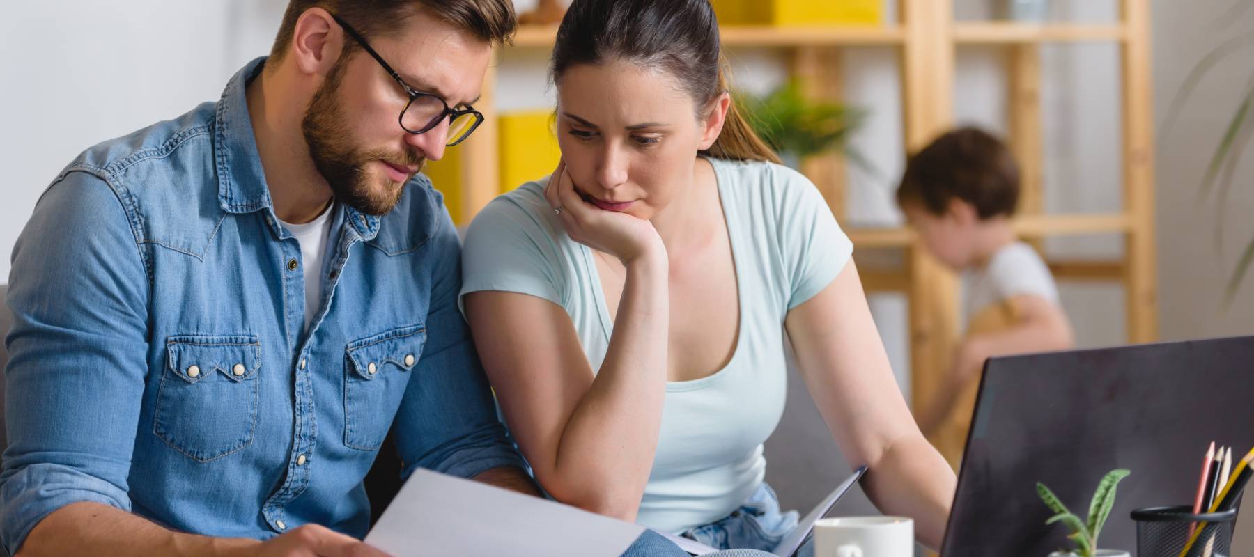 Family with a child having financial problems, doing home budgeting, calculating expenses.