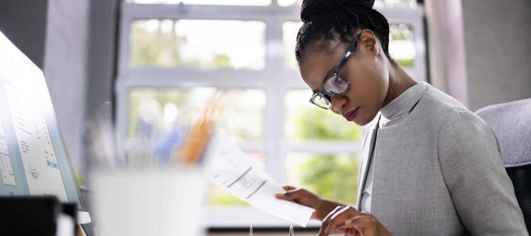 African American Accountant Or Auditor With Calculator
